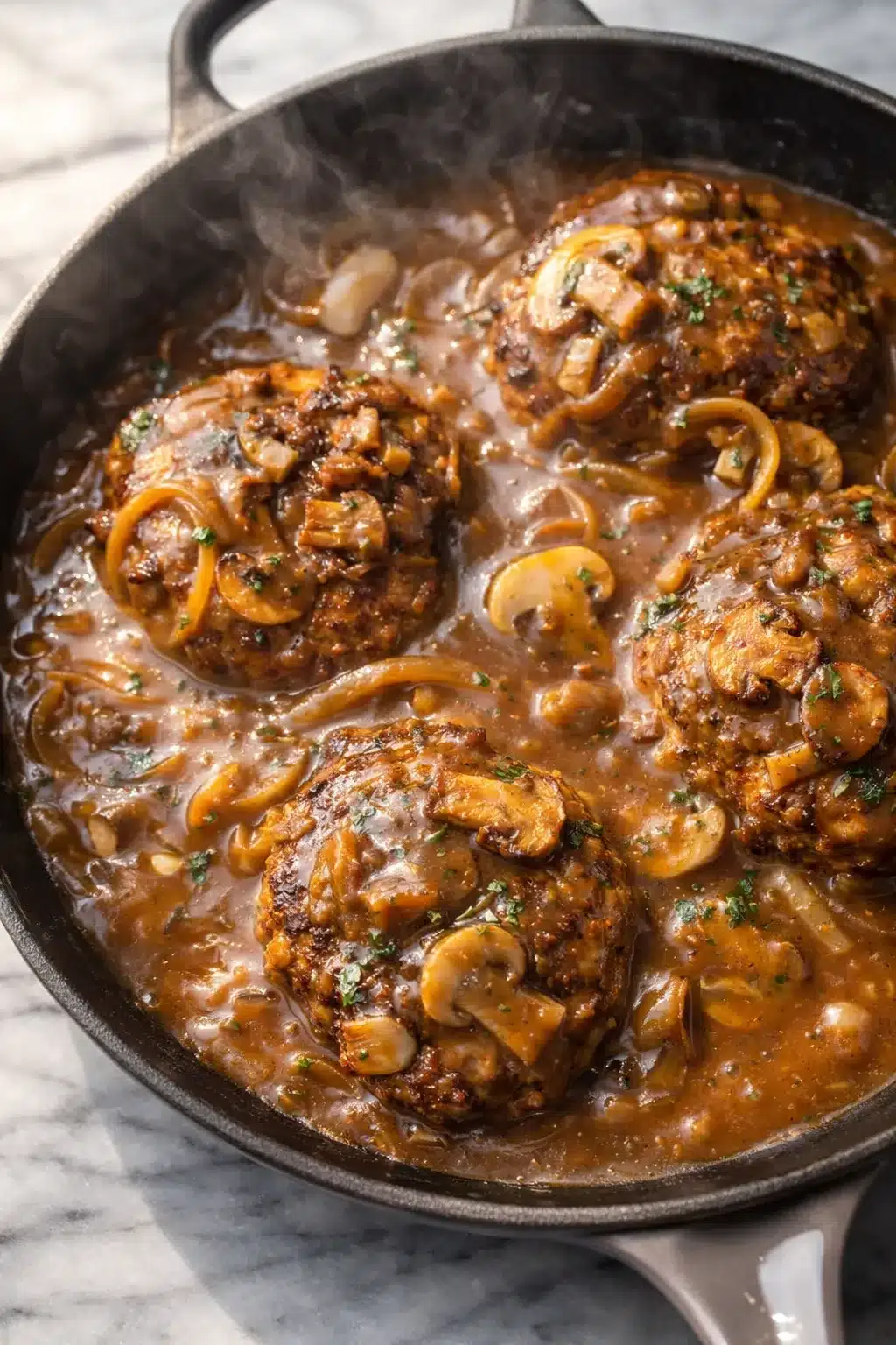 Easy Salisbury steak patties in mushroom gravy in a skillet