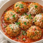 Ground turkey and kale meatballs in marinara sauce topped with Parmesan and parsley