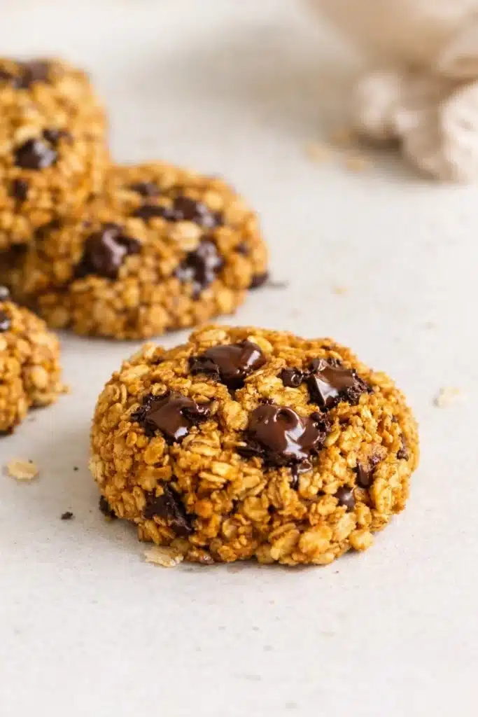 Healthy Pumpkin Oat Cookies | Easy & Delicious Treat 12 Close-up of healthy pumpkin oat cookie with melted chocolate chips on light surface