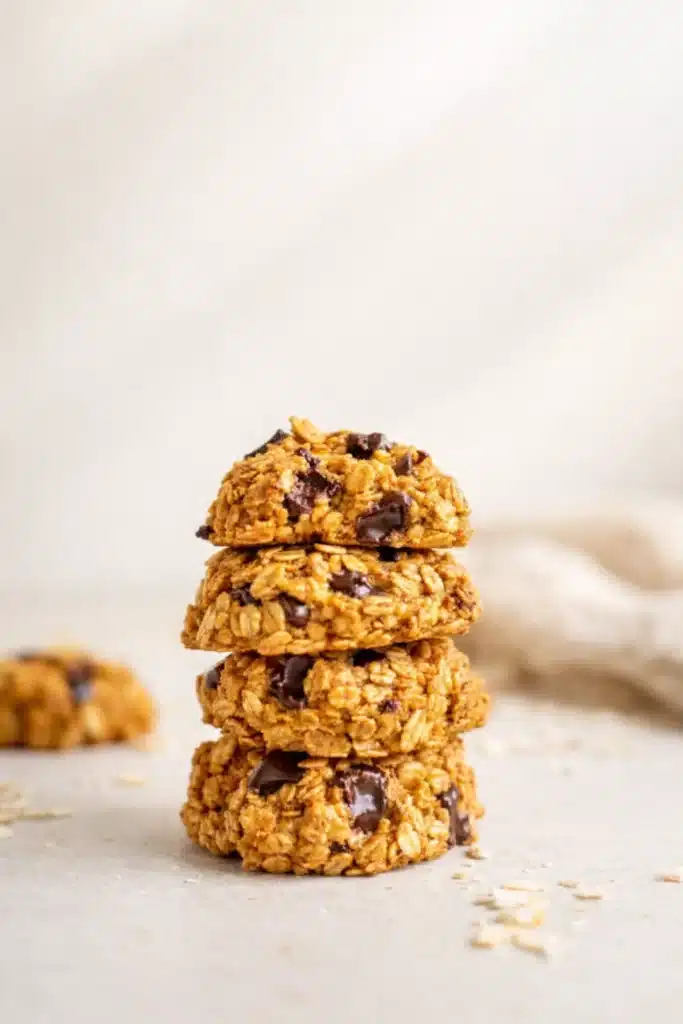 Healthy Pumpkin Oat Cookies | Easy & Delicious Treat 11 Stack of healthy pumpkin oat cookies with chocolate chips on beige background
