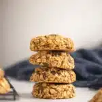 Stack of healthy pumpkin oat cookies with chocolate chips on light background