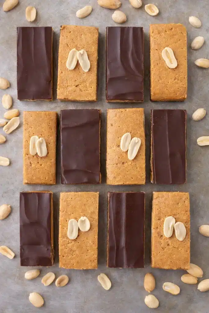 Homemade peanut butter protein bars with chocolate topping and peanuts