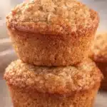 Moist apple muffins for babies stacked on a plate with golden crust
