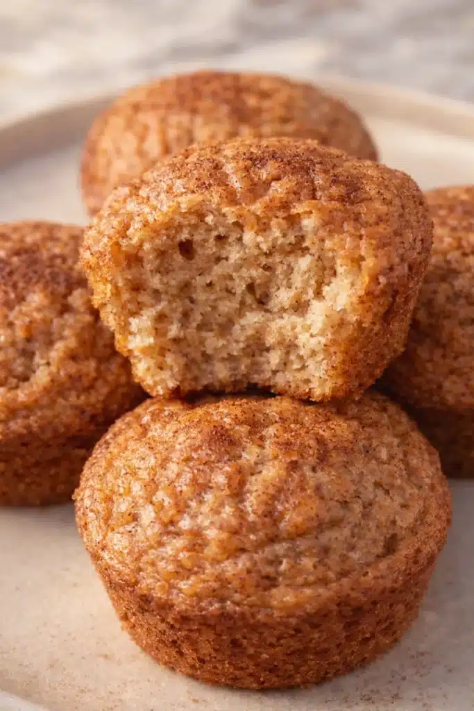 Moist apple muffins for babies with cinnamon on a beige plate