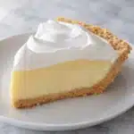 Slice of No Bake Lemon Meringue Pie with graham crust and fluffy meringue topping