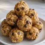 Peanut butter energy bites with oats and chocolate chips on a white plate