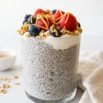 Creamy protein chia pudding topped with granola, yogurt, and fresh berries