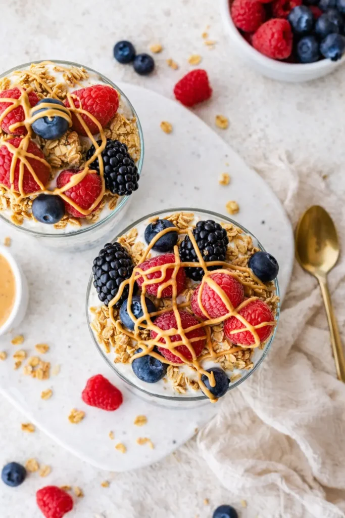 Protein chia pudding bowls with granola, berries, and peanut butter drizzle