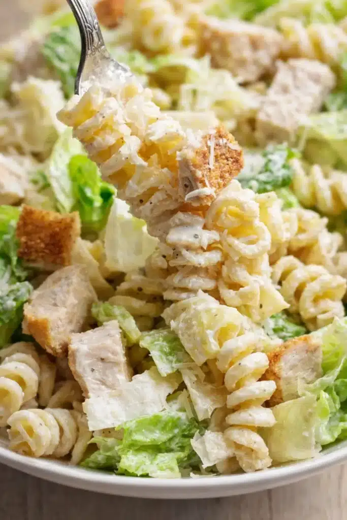 Simple Chicken Caesar Pasta Salad with creamy dressing, lettuce, chicken, and Parmesan