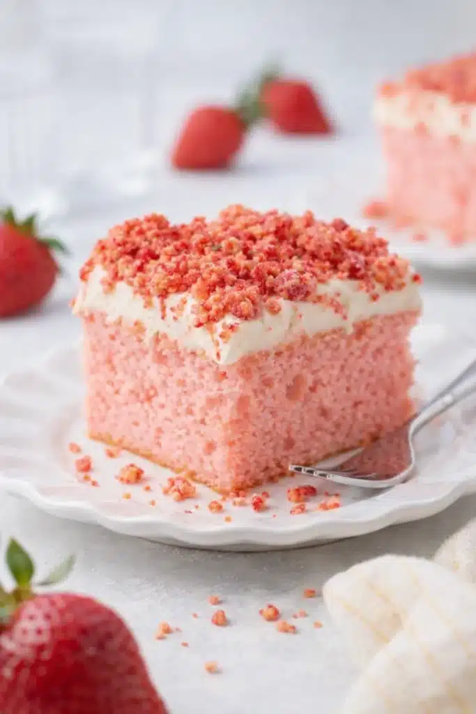 Strawberry Crunch Cake slice with vanilla frosting and crumble topping