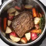 Tender Instant Pot pot roast with carrots and potatoes in savory broth