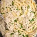 Creamy crockpot chicken alfredo pasta with parmesan and parsley