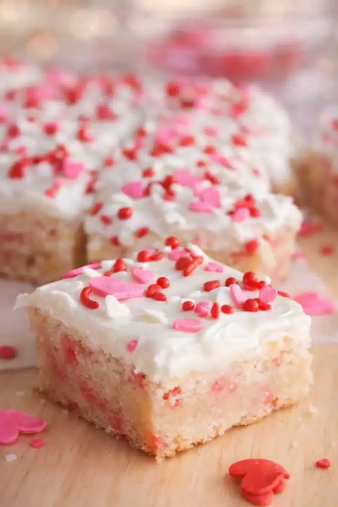 Valentine sugar cookie bar with white frosting and heart sprinkles
