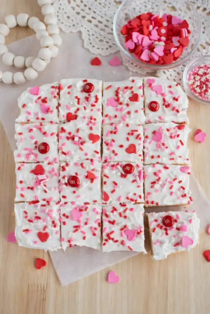 Valentine sugar cookie bars with frosting and heart sprinkles