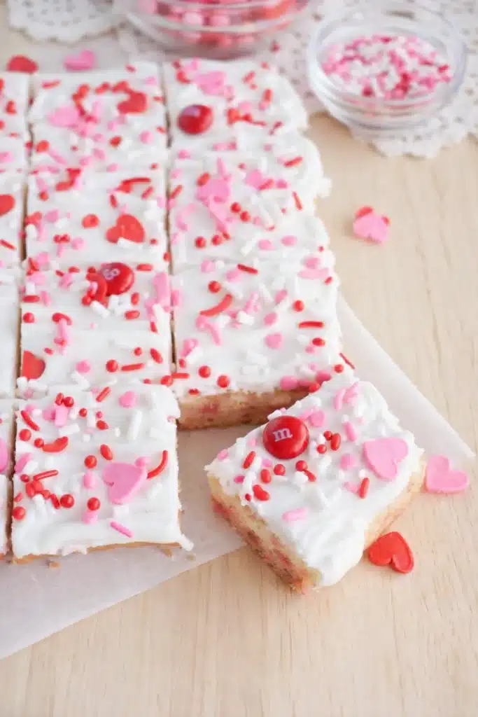 Valentine sugar cookie bars with frosting and pink sprinkles