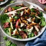 Winter salad with spinach, apple, Gorgonzola, pancetta, and candied walnuts