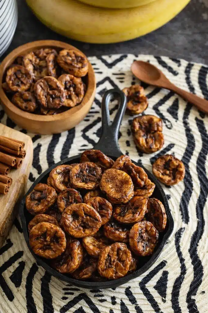 Air Fryer Bananas with Cinnamon in skillet with cinnamon sticks
