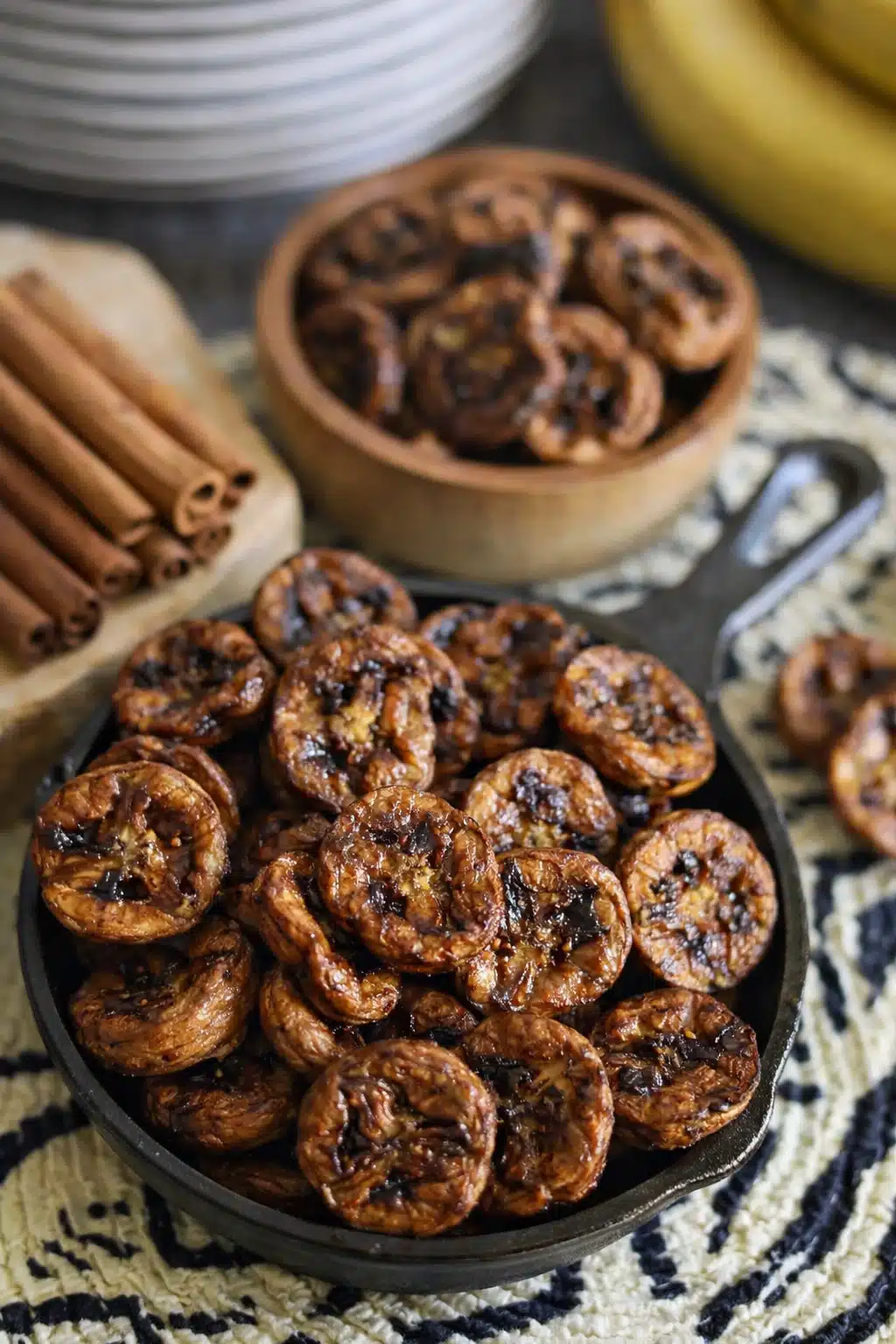 home 7 Caramelized air fryer banana slices in skillet with cinnamon sticks