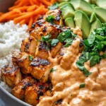 Bang Bang Chicken Bowl with rice, avocado, carrots and creamy spicy sauce