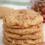 Stack of soft brown sugar rhubarb cookies with visible rhubarb pieces on marble surface