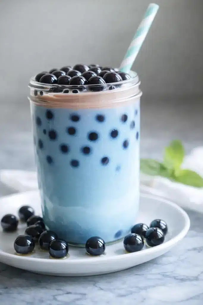 Butterfly Blue Boba Tea Recipe | Creamy, Colorful & Easy 5 Butterfly blue boba tea with glossy tapioca pearls and striped straw