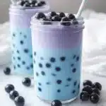 Butterfly blue boba tea in glass jars with pearls and lavender layer