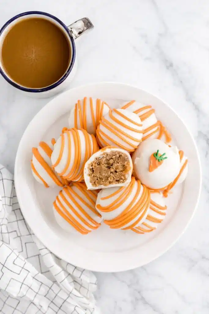 Top view of Carrot Cake Cheesecake Bites with orange drizzle and coffee cup