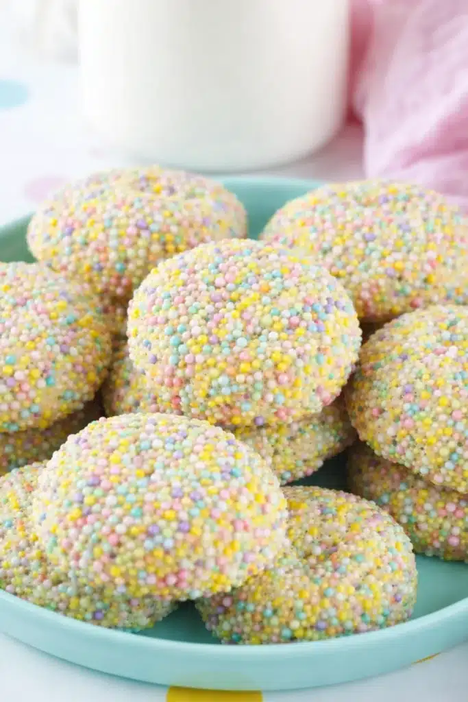 Close up Easter Cookies covered in pastel sprinkles on mint plate
