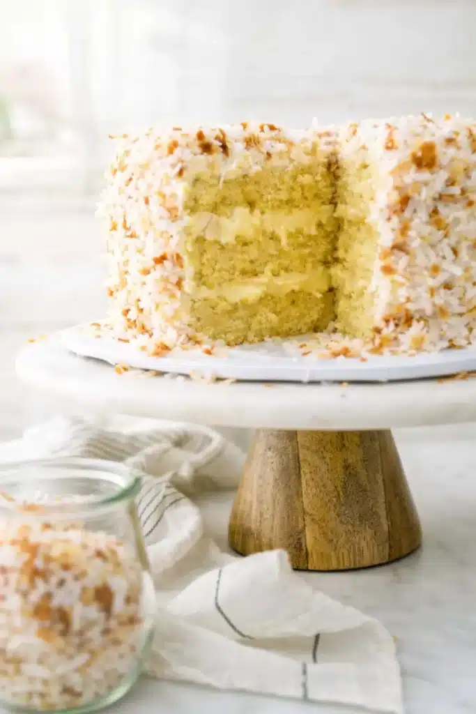 Coconut custard cake with slice cut showing creamy custard layers