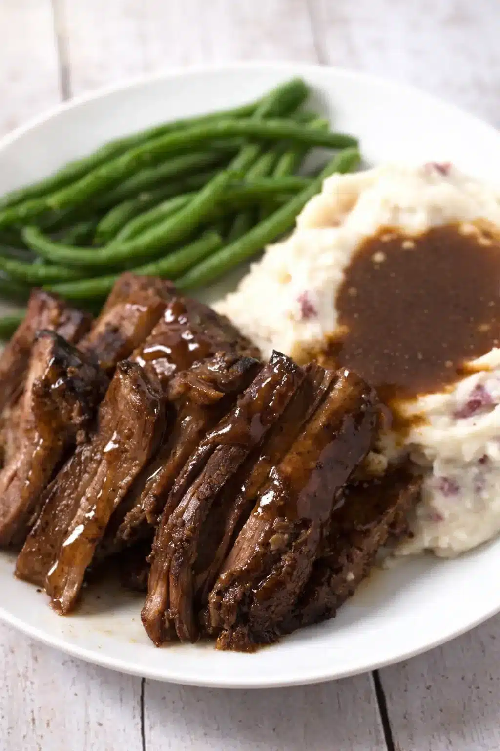 Tender Crock Pot chuck roast with mashed potatoes and green beans
