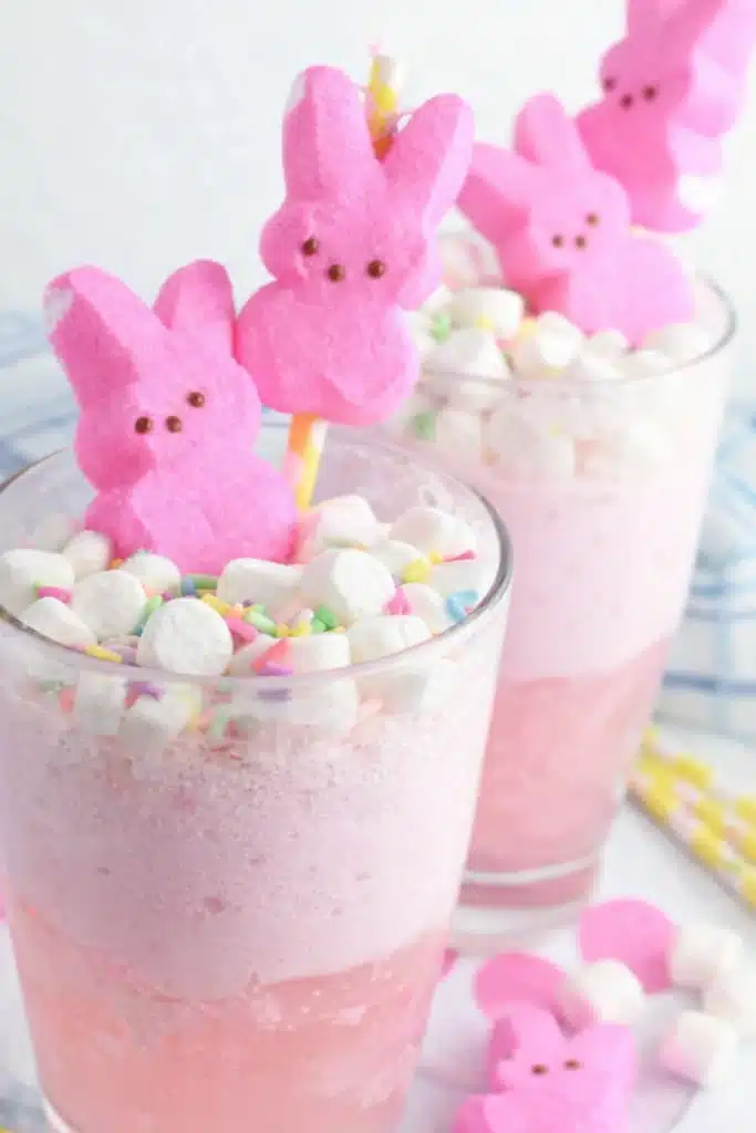 Easter Bunny Punch – Fun, Creamy, & Kid-Friendly Drink 6 Easter Bunny Punch topped with marshmallows, sprinkles, and pink Peeps in clear glasses