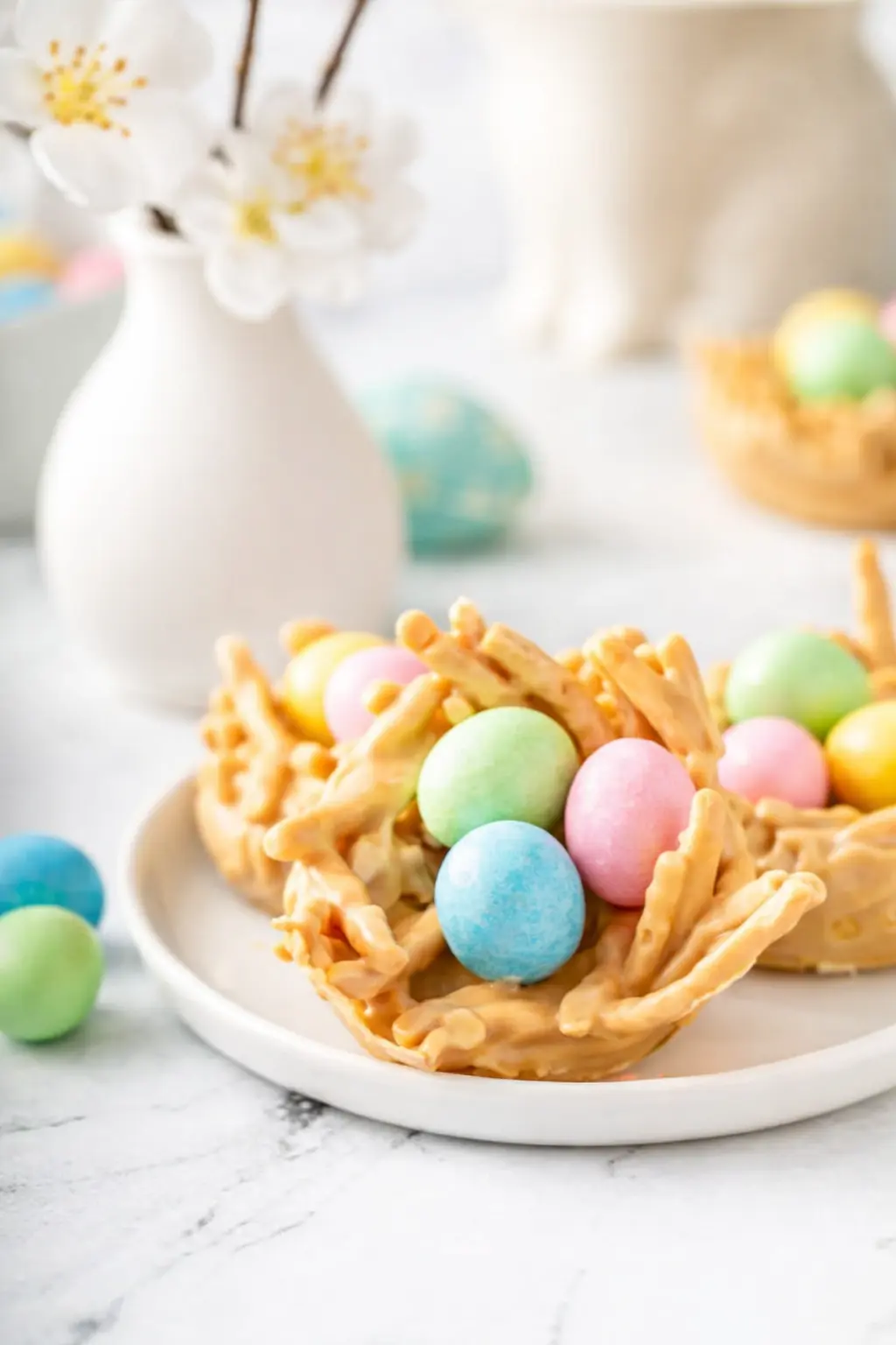 home 8 Easter Egg Peanut Butter Haystacks with pastel candy eggs on a white plate