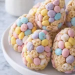Easter Egg Rice Krispie Treats with pastel candies on a white plate