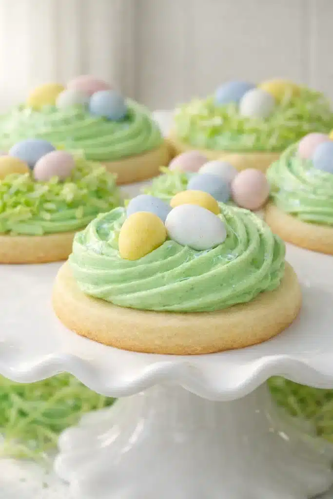 Easter Sugar Cookies with green buttercream nests and pastel candy eggs