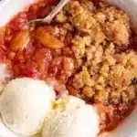 Easy rhubarb crisp with vanilla ice cream in a rustic bowl
