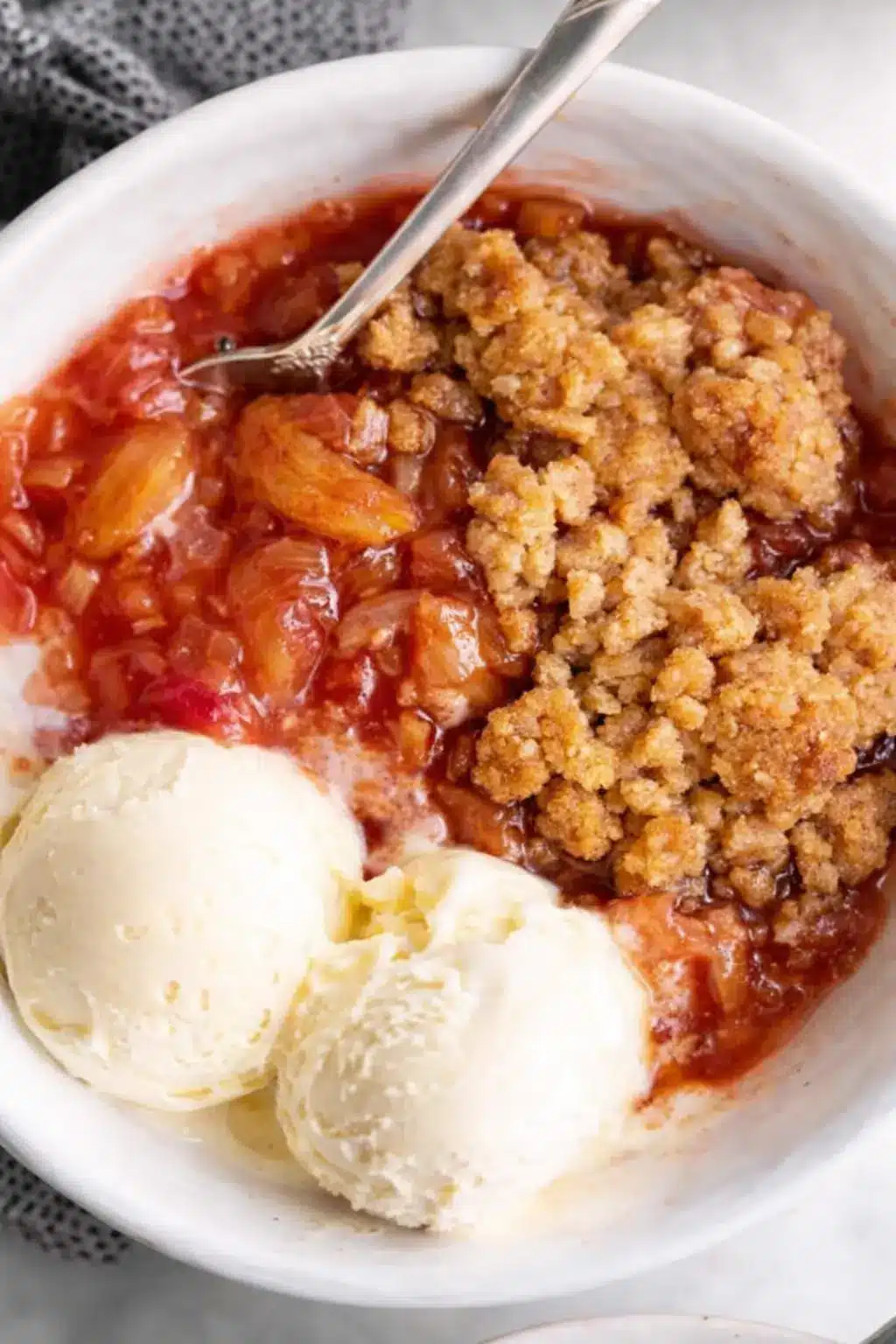 Easy rhubarb crisp with vanilla ice cream in a rustic bowl