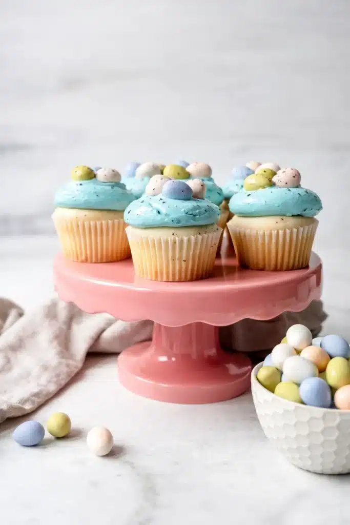 Egg Easter Cupcakes Easy Beautiful Easter Treat 11 Egg Easter Cupcakes with blue frosting on pink cake stand
