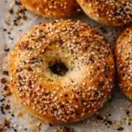 Golden high protein cottage cheese bagels with everything seasoning on baking surface