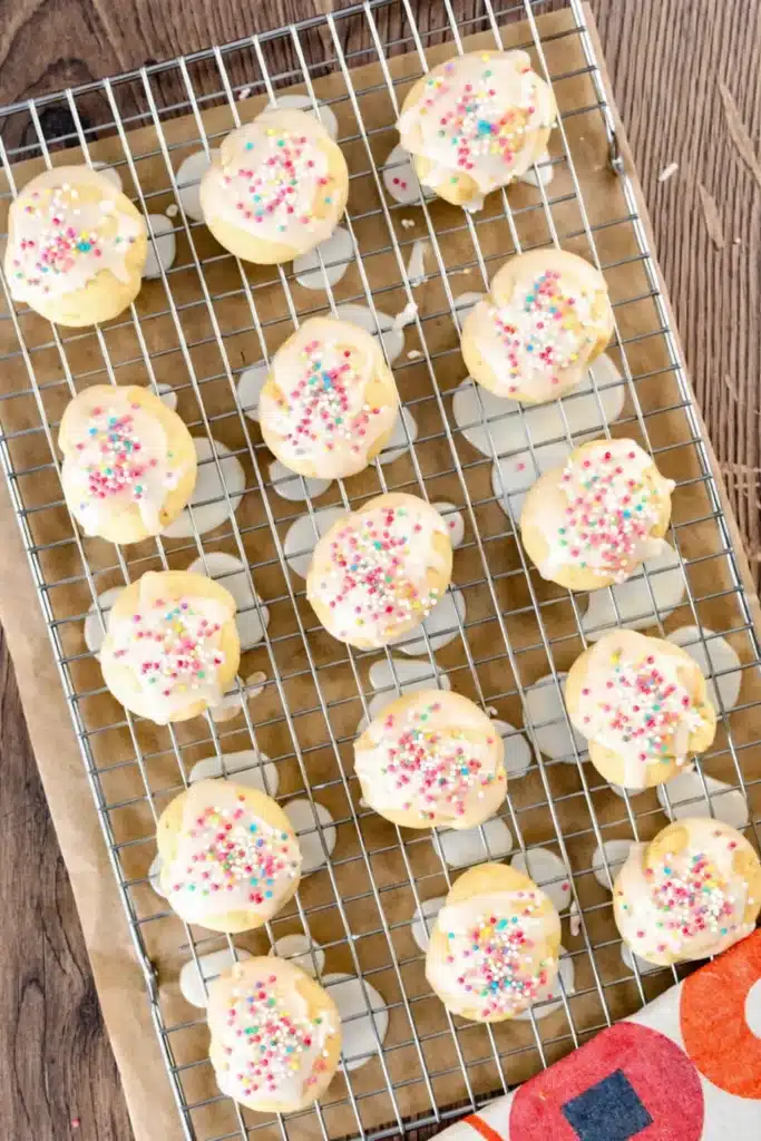 Italian Easter Cookies : Easy Uncinetti Recipe 5 Italian Easter Cookies Uncinetti with lemon glaze and colorful sprinkles on cooling rack