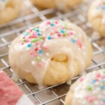 Italian Easter Cookies with white glaze and colorful sprinkles on cooling rack