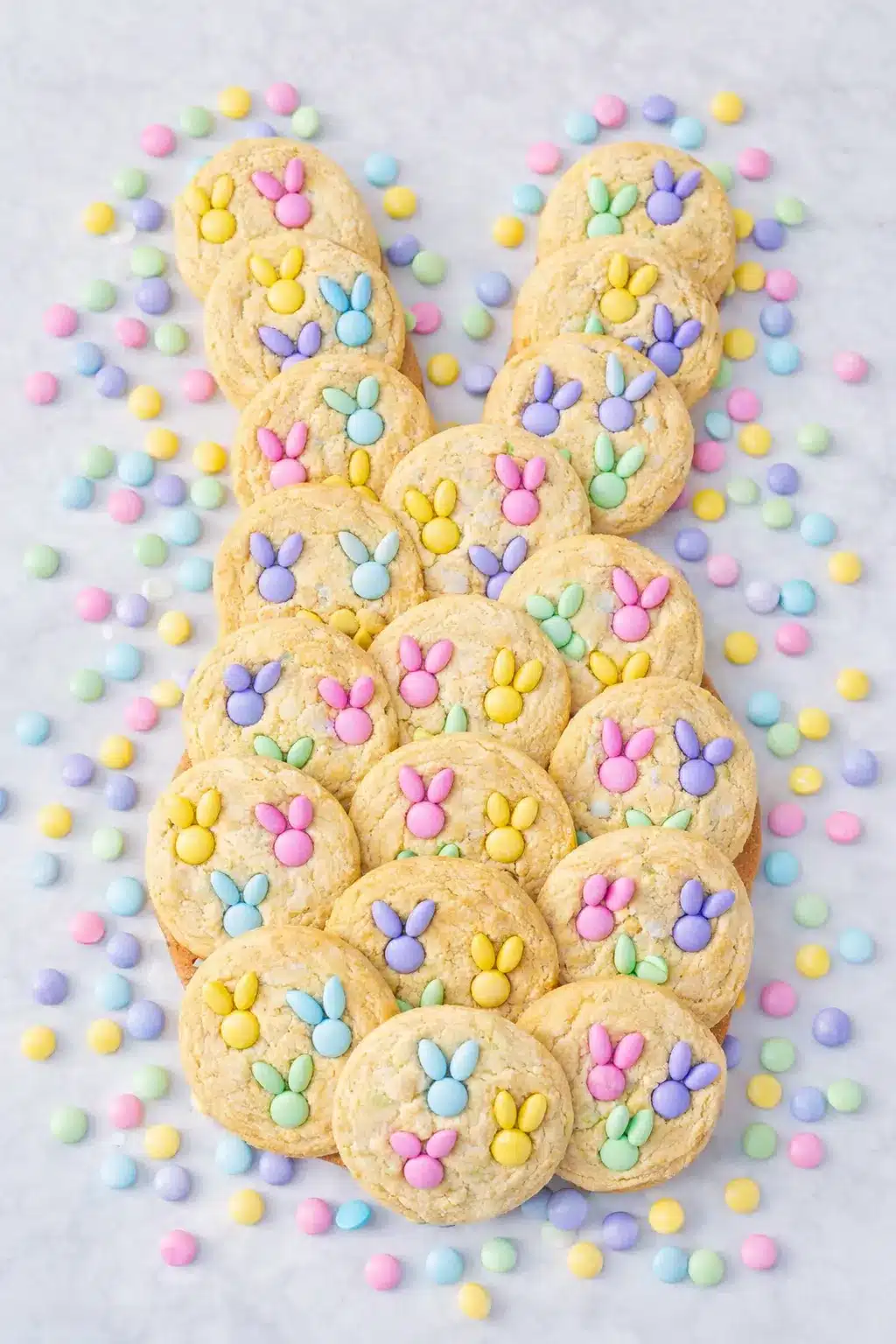 Pastel M&M Bunny Cookies arranged in bunny shape on linen background