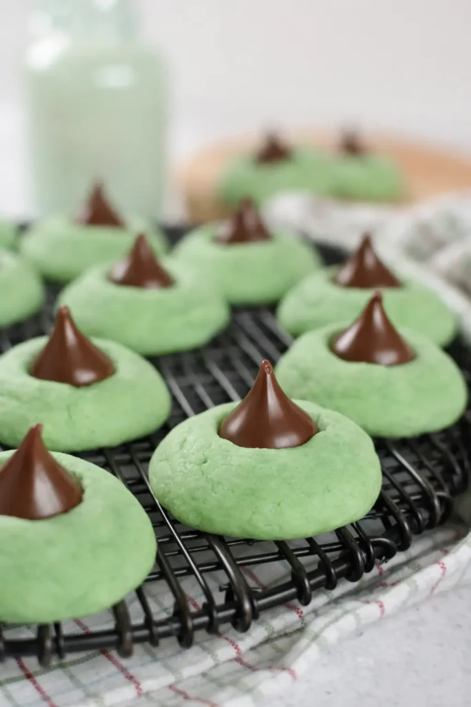 Mint Chocolate Kiss Blossom Cookies cooling on black rack