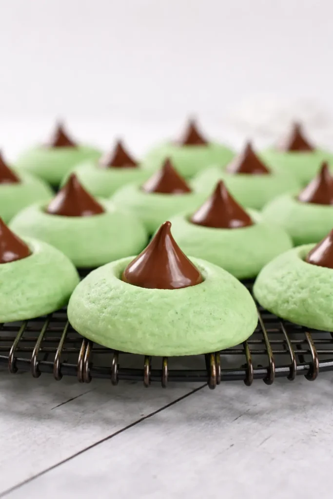 Mint Chocolate Kiss Blossom Cookies cooling on metal rack