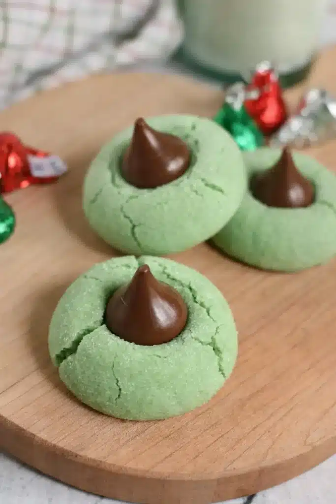 Mint Chocolate Kiss Blossom Cookies on wooden board with chocolate centers