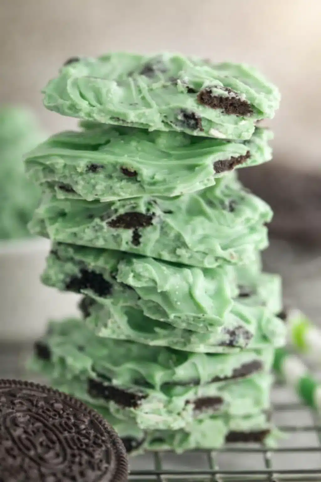 Stacked mint Oreo bark pieces with white chocolate and cookie chunks