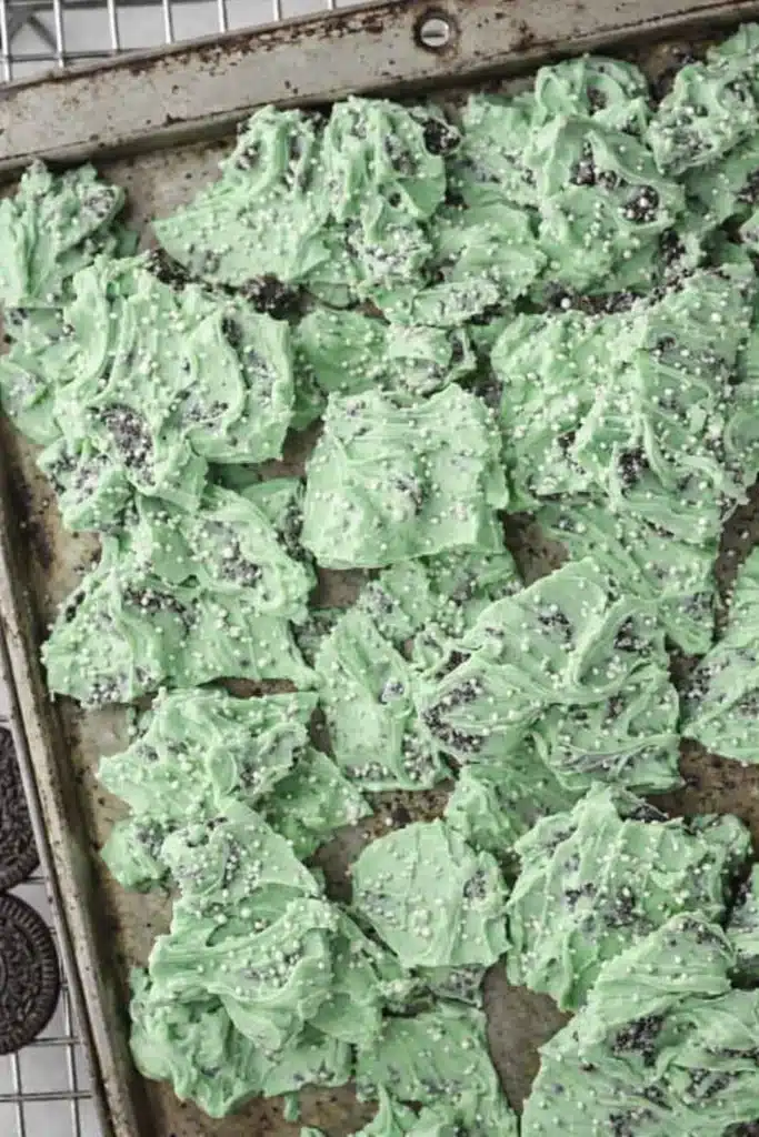 Mint Oreo Bark No Bake White Chocolate Dessert 4 Mint Oreo Bark pieces with cookie chunks and white sprinkles