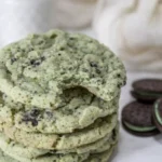 Stack of mint Oreo cookies with chocolate crumbs and soft chewy centers
