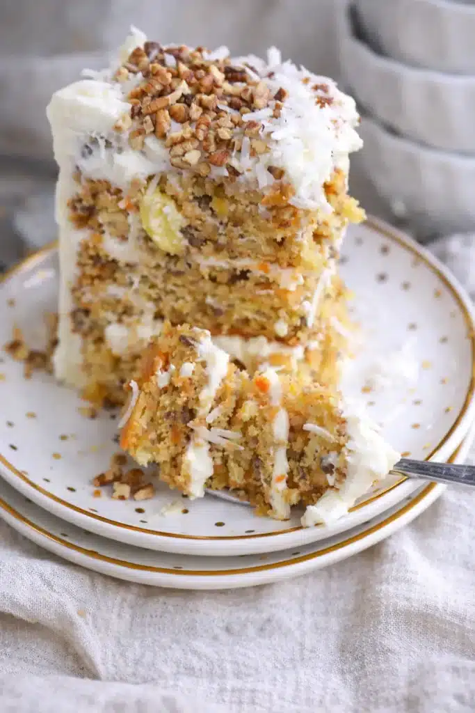 To Die For Carrot Cake slice with cream cheese frosting and pecans
