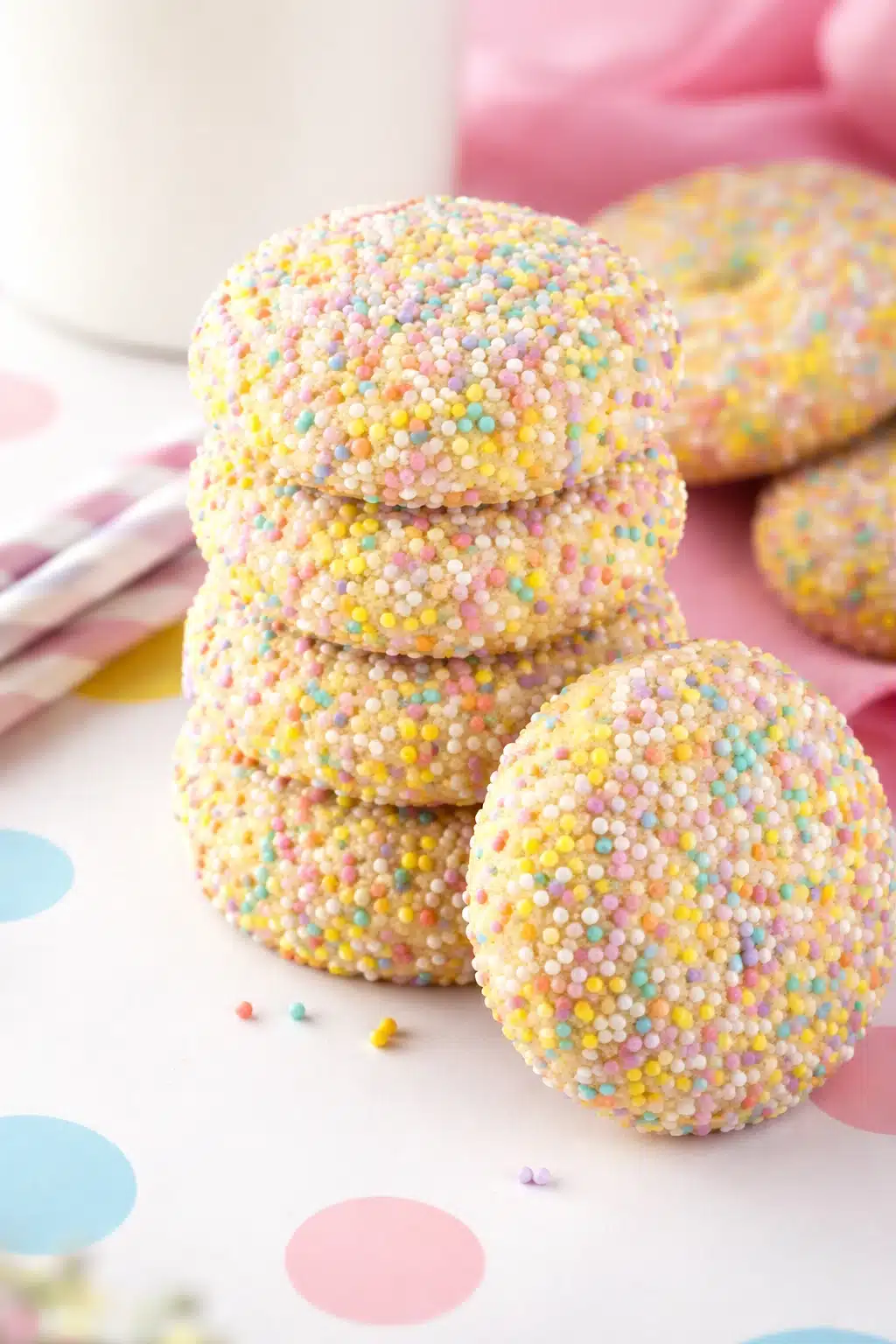 home 6 Stacked Easter cookies coated in pastel sprinkles on marble surface