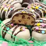 Peanut butter cookie dough Easter eggs coated in chocolate with pastel sprinkles